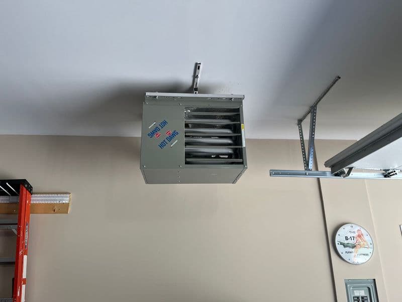 Ceiling-mounted garage heater with adjustable vents and control panel.