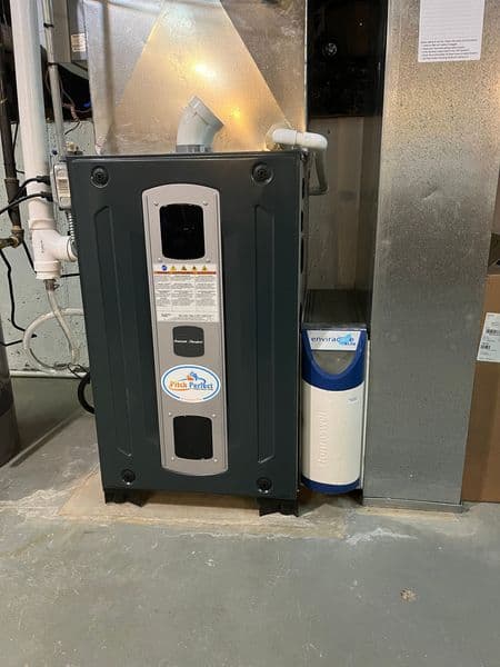 Energy-efficient heat pump unit installed in a home basement for climate control.