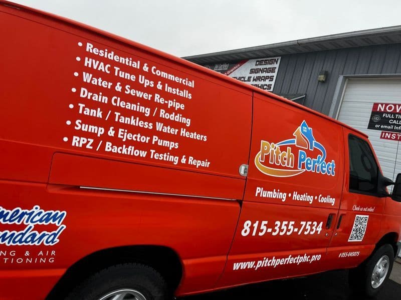 Pitch Perfect van featuring plumbing, heating, and cooling services with contact details.
