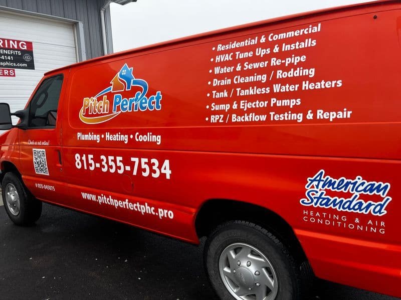Pitch Perfect Plumbing, Heating, and Cooling service van with contact details and services listed.