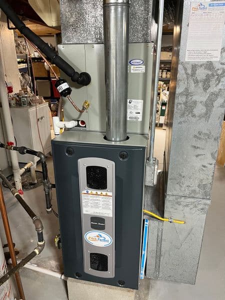 High-efficiency furnace installation in a residential basement. Energy-saving features visible.